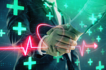 Multi exposure of heart hologram on abstract background with two men handshake. Concept of medical...