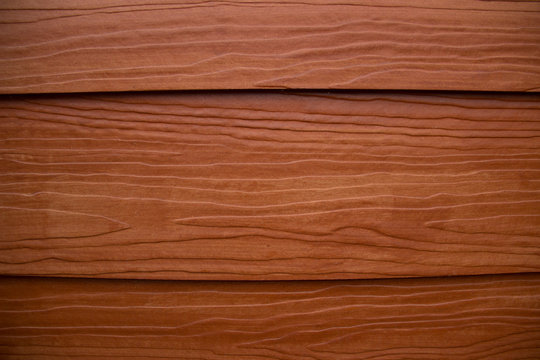 An orange-red-brown Shera wood texture background