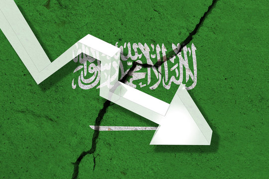 Saudi Arabia Flag on the cracked wall with arrow falling down. Concept of decrease in the country.