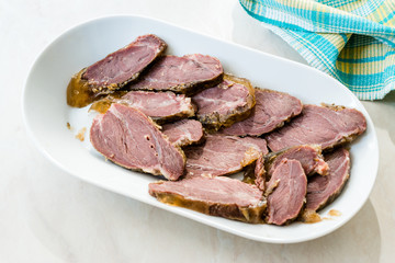 Smoked Meat Veal Cheek Slices on Wooden Board. Ready to Eat.
