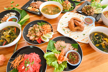 Table food served on plate / Tradition northeast food Isaan delicious on plate with fresh vegetables - Many variety various Thai menu Asian food on a wooden table