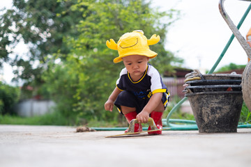 asian one year old baby baby playing at construction site, kids and baby concept.