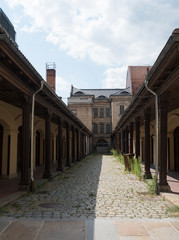 Obraz premium Street with atrium and pillars in Historic old town of Zittau, Saxony, Germany. Summer sunny day, blue sky background