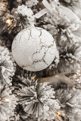 Fototapeta na wymiar New Year decor. Interior detail, closeup. Christmas tree decoration. White ball