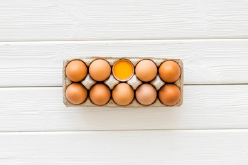Fresh eggs for organic food on white wooden background top view