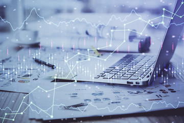 Financial market graph hologram and personal computer on background. Double exposure. Concept of forex.