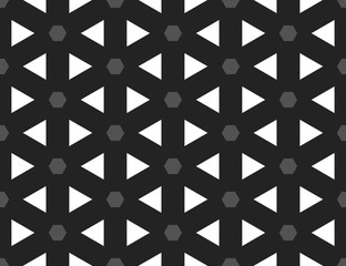 Vector seamless geometric pattern. Shaped grey hexagons and white triangles, black background.