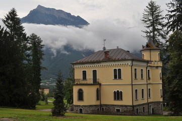 Fototapeta na wymiar Yellow castle in Italy and mountains