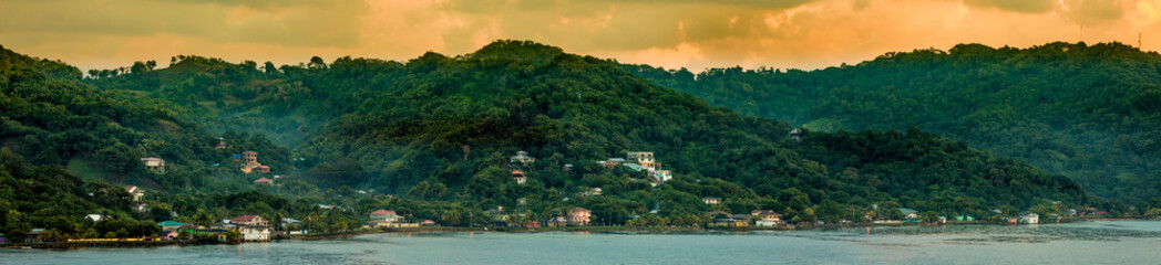 Fototapeta na wymiar Panoramic view of Roatan, Honduras at sunrise, as seen from the sea.