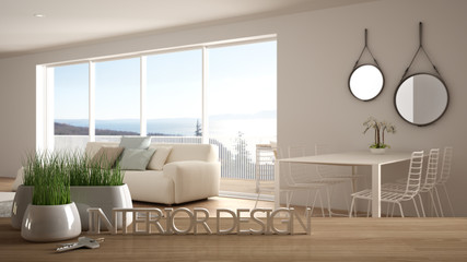 Wooden table, desk or shelf with potted grass plant, house keys and 3D letters making the words interior design, over blurred modern living room, project concept copy space background