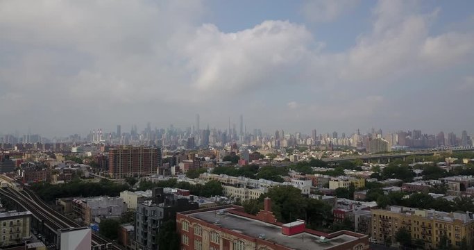 Drone moving over Bronx with Manhattan skyline background