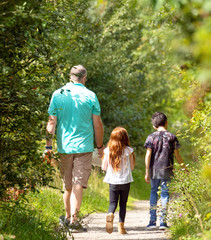 Fototapeta premium Man taking his children on a nature walk