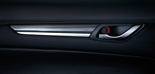 Obraz na płótnie Canvas Vehicle interior of a modern car with black leather door