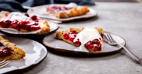 Bakery products. Summer pie with berries. Galeta with cherries sprinkled with powdered sugar.