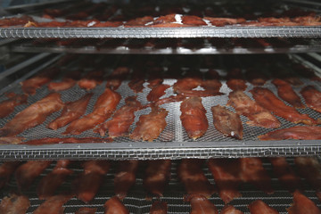 The process of drying red fish in the dryer.System for drying fish. Stockfish, salted, fish chips,...