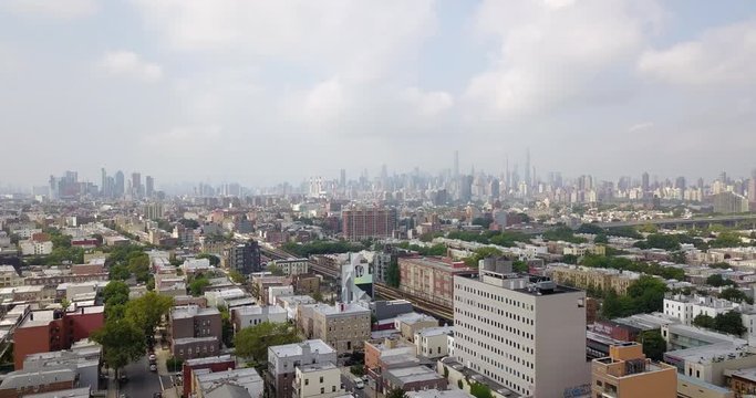 Drone over the Bronx with Manhattan skyline background fog