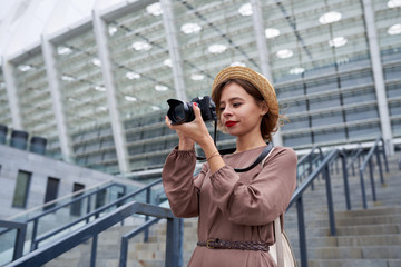 Girl photographer takes pictures in the city