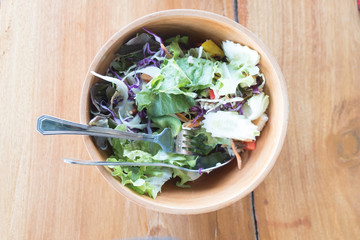 Fresh vegetable salad in a wooden bowl
