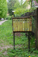 old rusty mailbox on green background