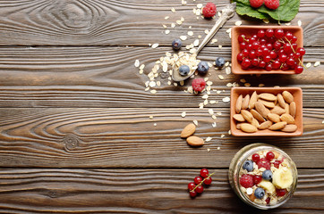 Flat lay top view at Fruit muesli in glass jar on kitchen wooden table