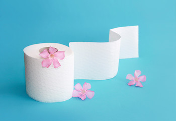 white toilet paper roll with flowers decor on a blue background