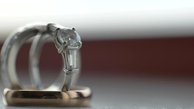 Macro pan right to left to reveal engagement rings