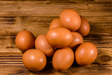 Pile of the hen eggs on wooden table