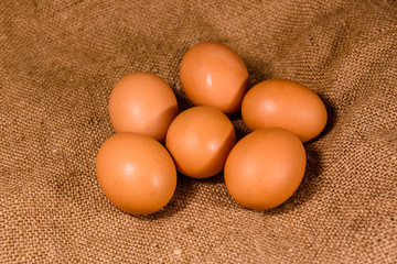 Pile of the hen eggs on sackcloth