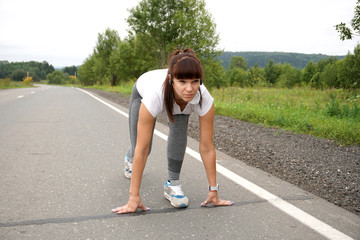 girl in a white t-shirt, gray pants goes in for sports