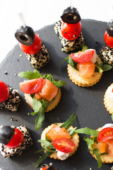 tasty and delicious catering stands on stone trays and on white wooden tables