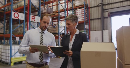Warehouse managers working together in loading bay 4k