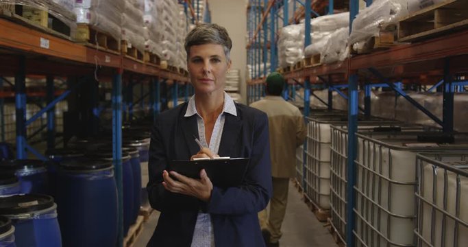 Female manager checks stock in a warehouse 4k