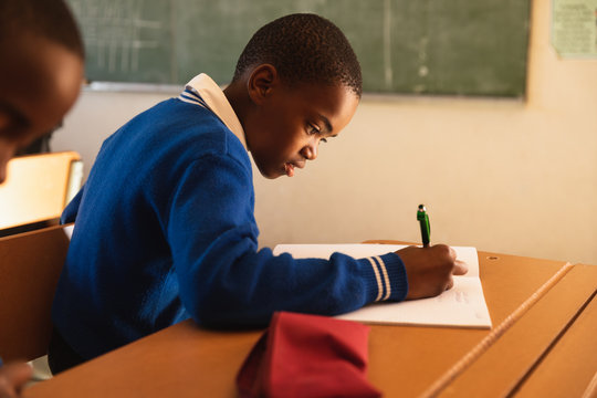 Schoolboy writing in a lesson at a township school