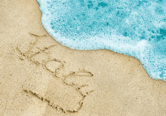 Fototapeta na wymiar Italy title on the light sand beach near the black sea coast. Italy lettering or inscription on the sand beach.