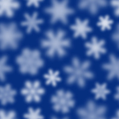 Christmas seamless pattern of white defocused snowflakes on blue background