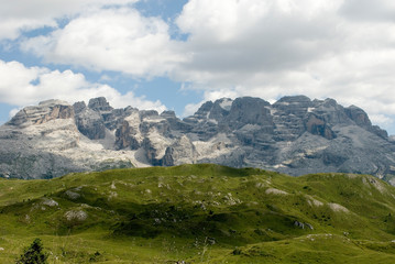 Fototapeta na wymiar mountains of Cima Tosa, Cima Brenta Peak and Grosté Pass, meadow, Dolomites, Madonna di Campiglio, summer, sport, trekking, hiking, travel, sun, clouds, Alps, Trentino Alto Adige, Italy