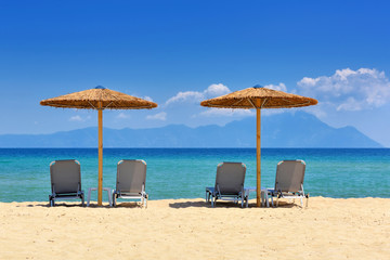 Umbrellas and chairs on the sandy beach. Sea view from beach
