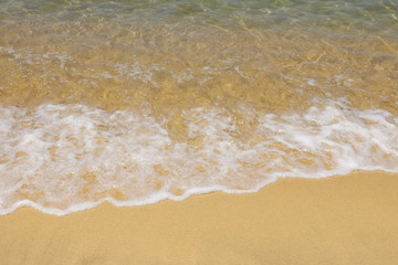 Soft wave of sea on sandy beach. Background. Selective focus.
