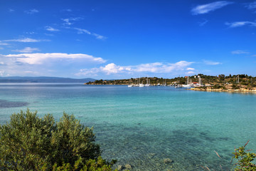 Beautiful calm sea lagoon with boats on the horizon at sunny day