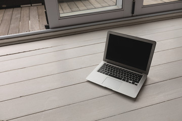 Laptop kept on a wooden surface