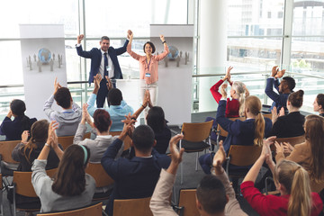 Business people applauding and celebrating in a business seminar