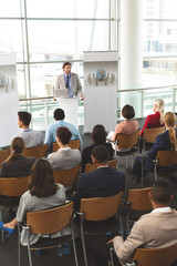 Male speaker with laptop speaks in a business seminar