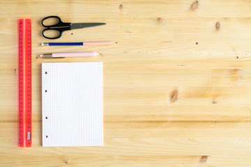 Copyspace on wooden background and group of office supplies