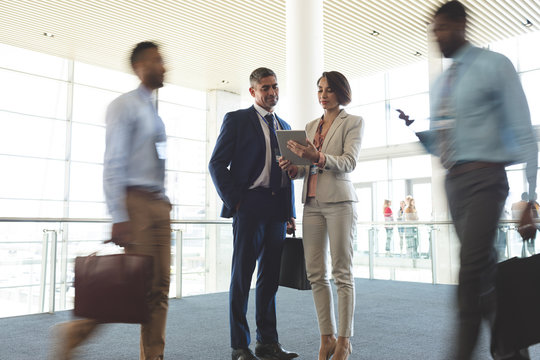 Business executives discussing over digital tablet