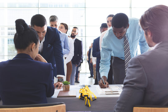 Business people checking in at conference registration table