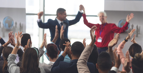 Business people applauding and celebrating in a business seminar