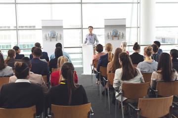 Asian business professional speaks at a business seminar