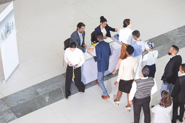 Business people checking in at conference registration table