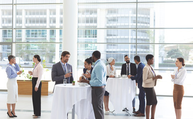 Business people interacting with each other at table during a seminar 