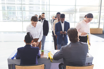 Business people checking in at conference registration table